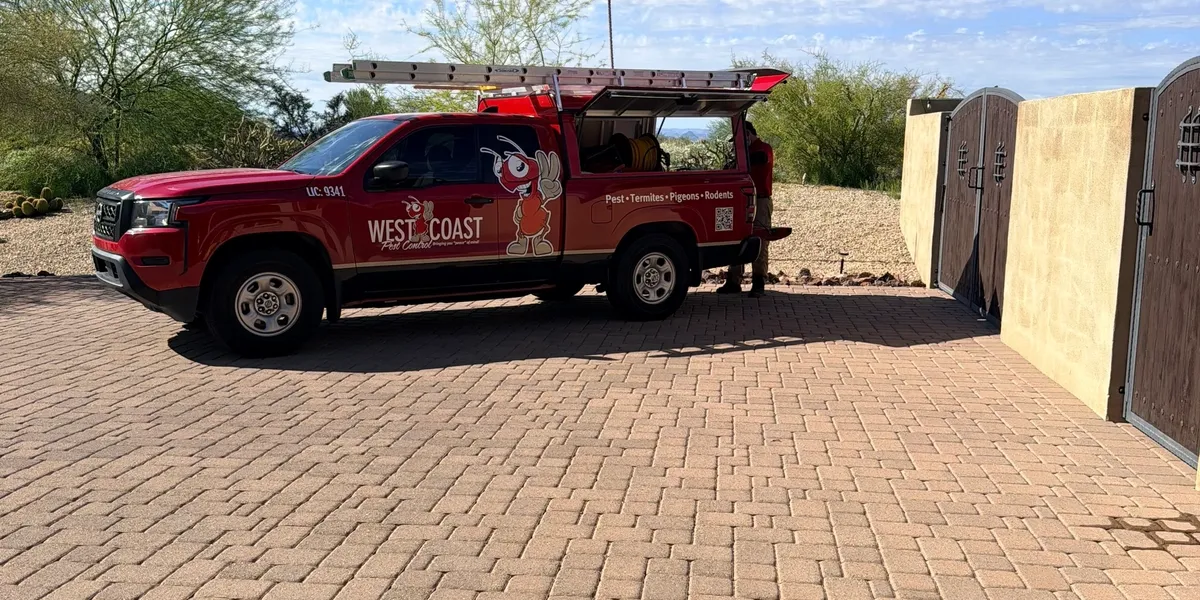 Red West Coast pest control truck with ladder